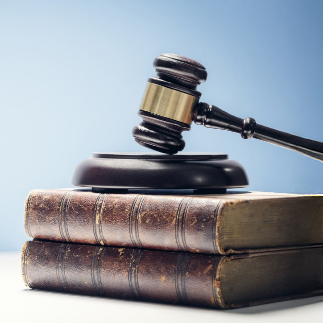 Gavel on stack of old books